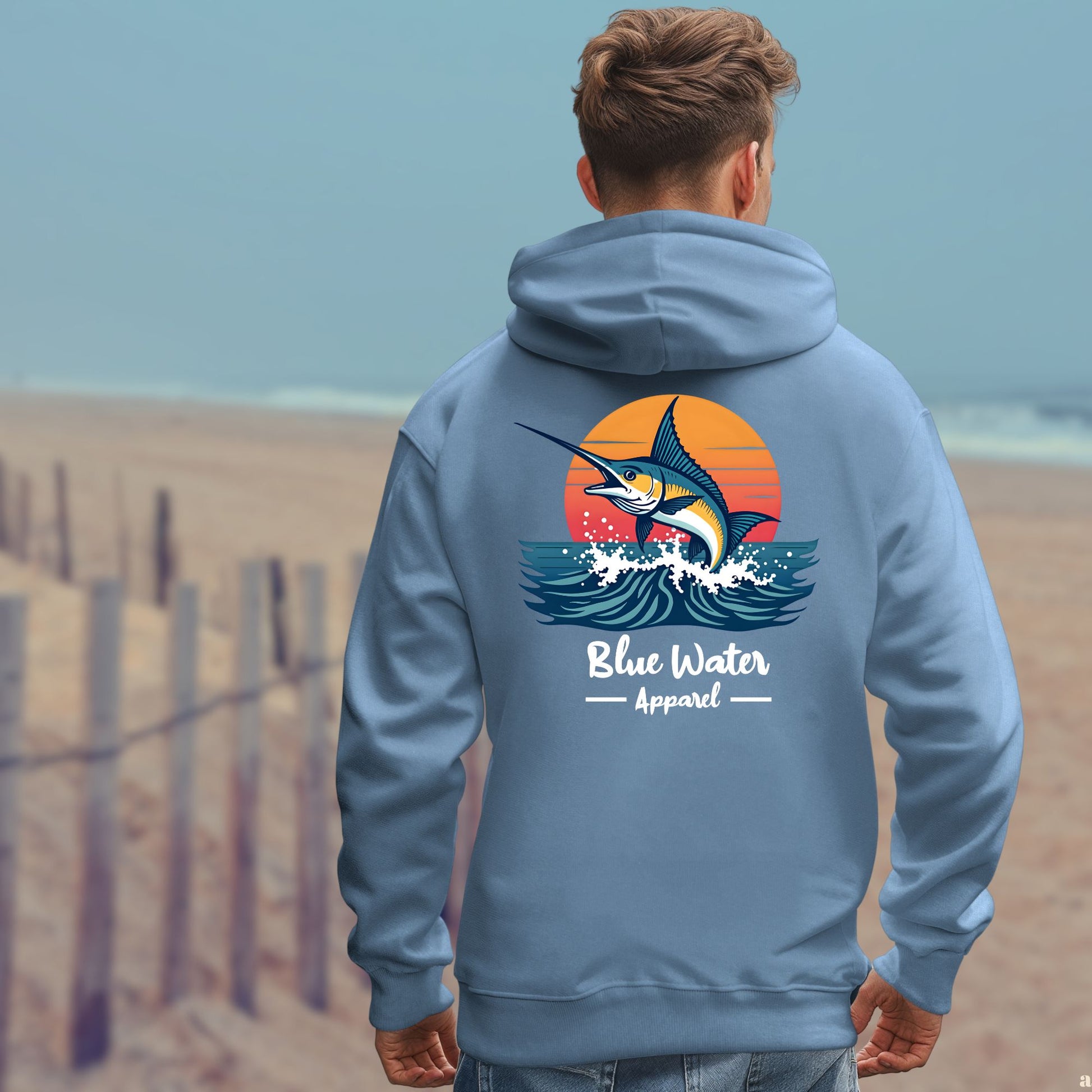 model on beach wearing indigo blue vintage marlin hoodie by blue water apparel