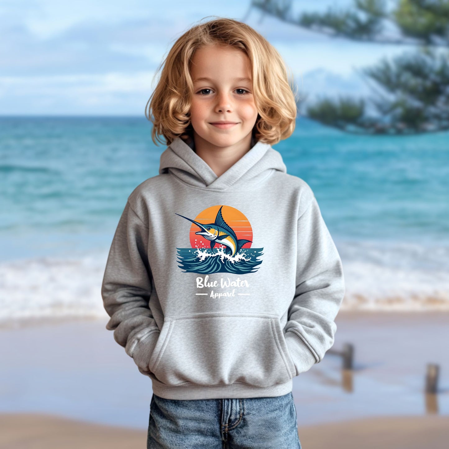 child model on beach wearing sport grey vintage marlin kids hoodie by blue water apparel
