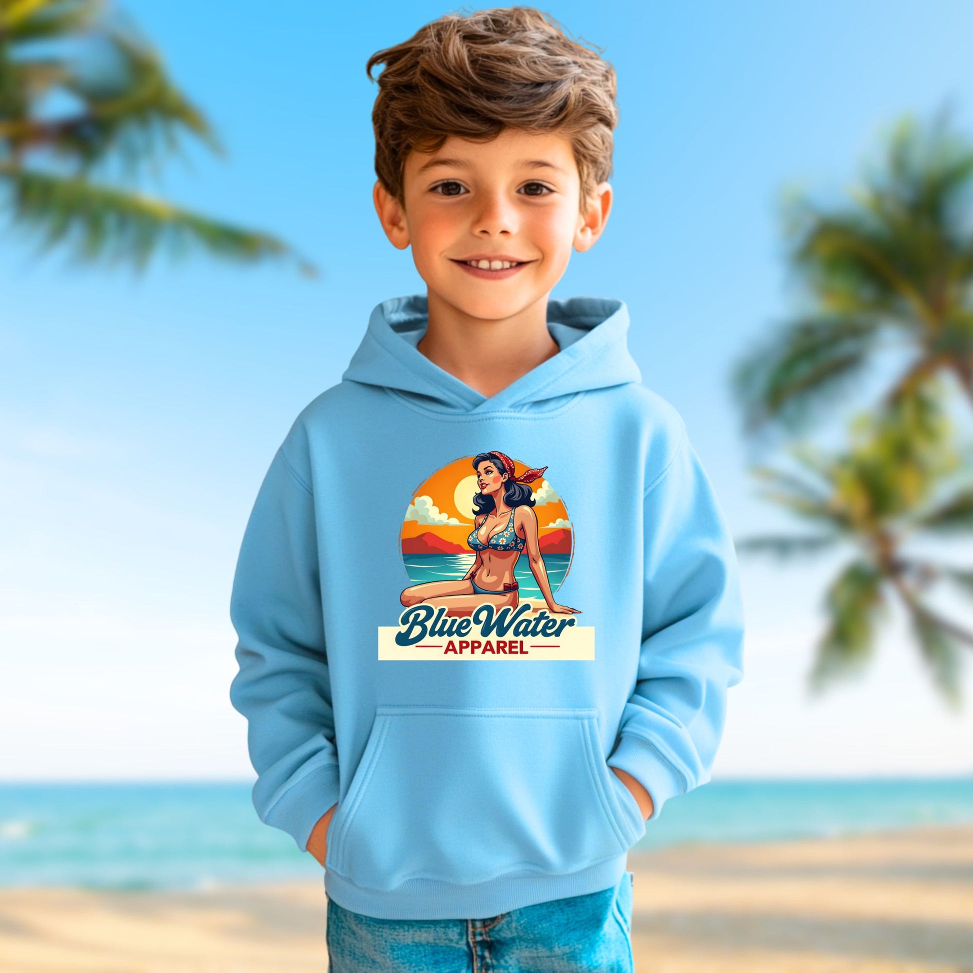 child model on beach wearing carolina blue vintage pin-up kids hoodie by blue water apparel