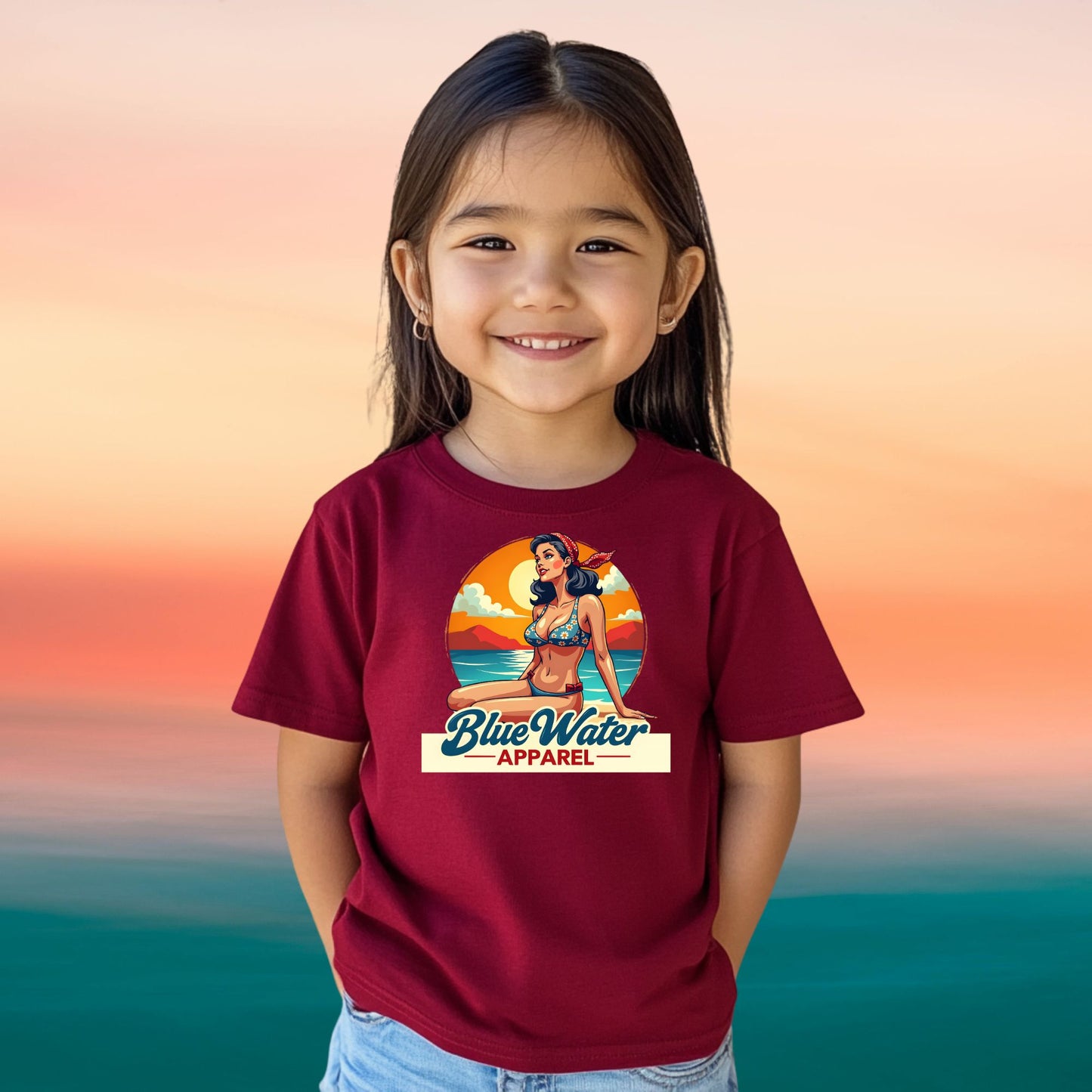 female child on beach wearing cardinal red vintage pin up tee by blue water apparel