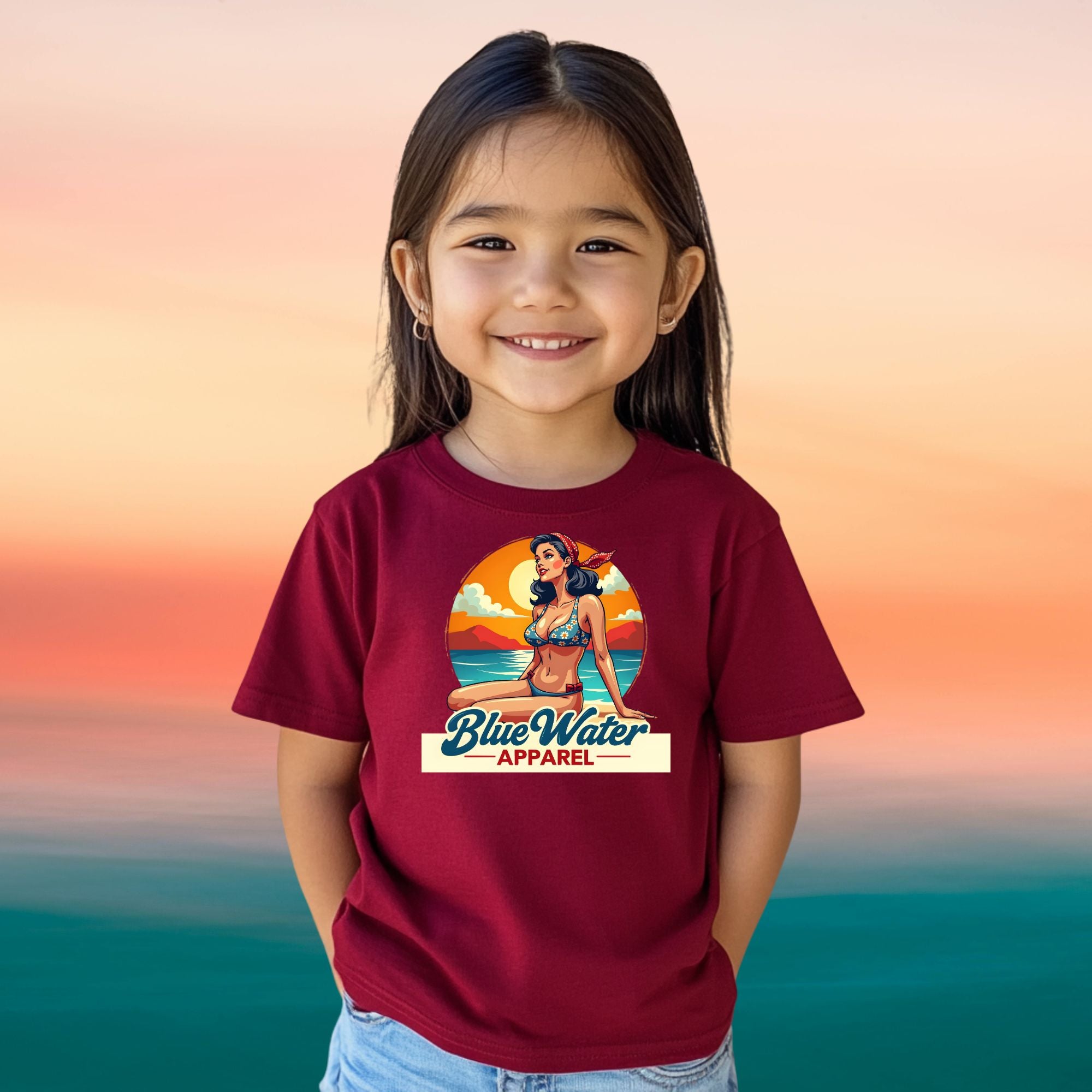 female child on beach wearing cardinal red vintage pin up tee by blue water apparel