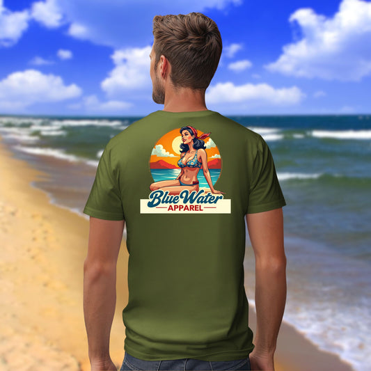 male model on beach wearing military green vintage pin up tee by blue water apparel