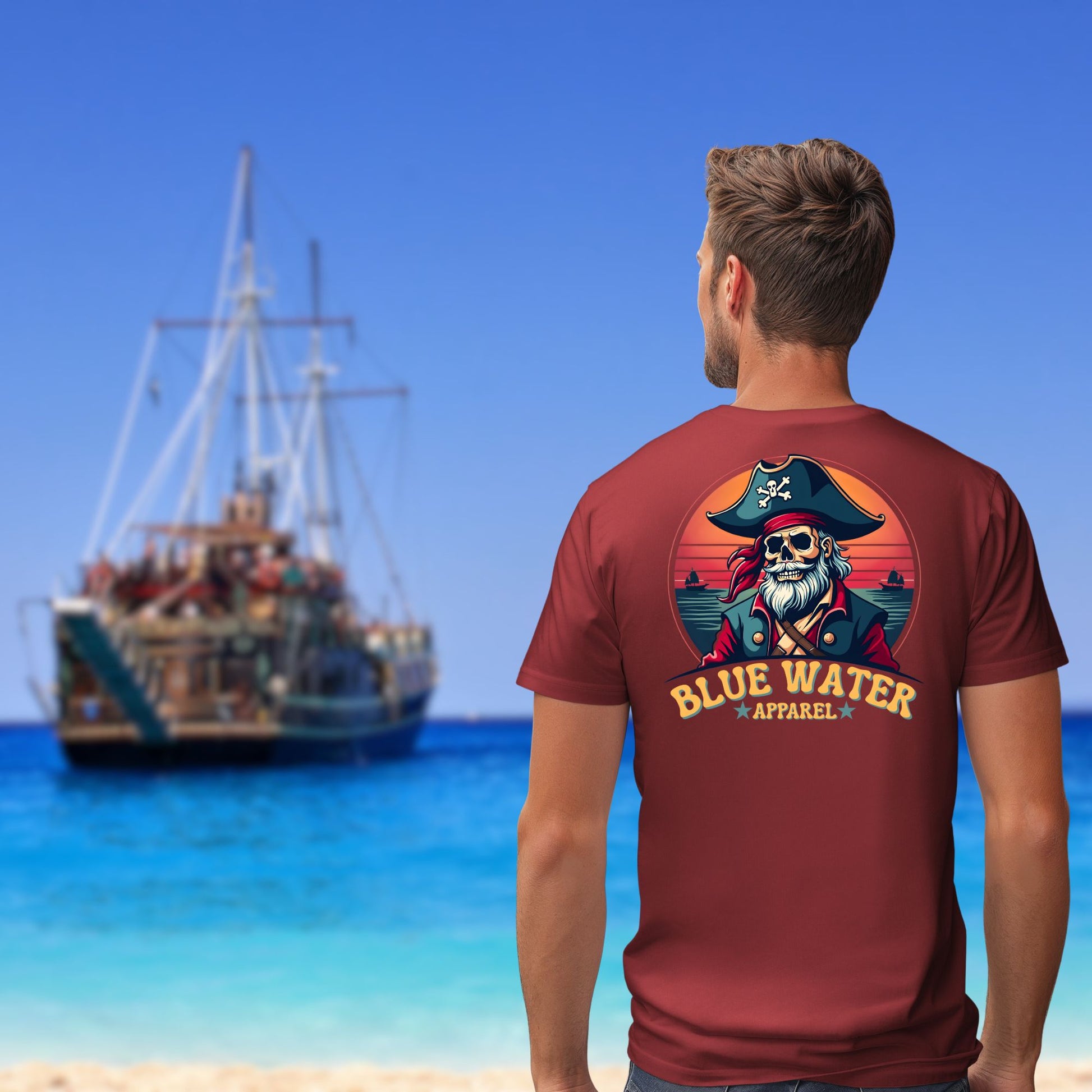 Model on beach looking at pirate ship wearing cardinal red vintage pirate tee
