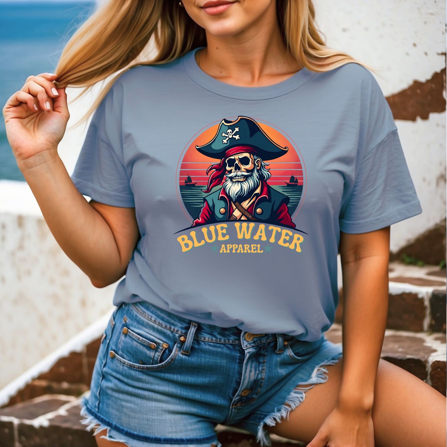 model wearing front graphic, steel blue vintage pirate tee by blue water apparel