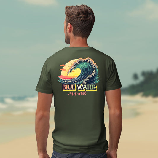 Male model on beach wearing the vintage surf tee in military green by blue water apparel