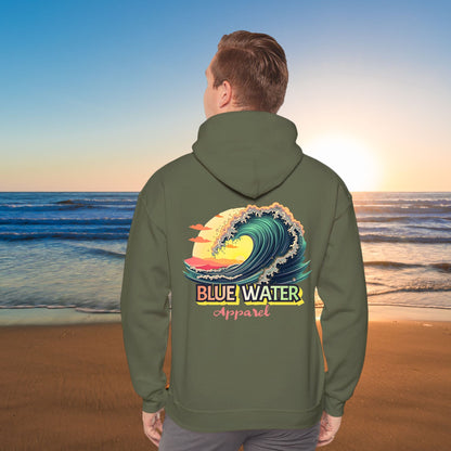 man on beach wearing military green vintage surf hoodie by blue water apparel