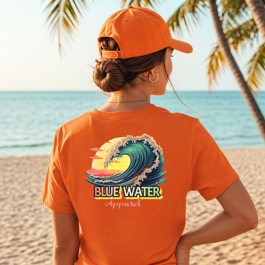 woman on beach wearing orange vintage surf tee by blue water apparel