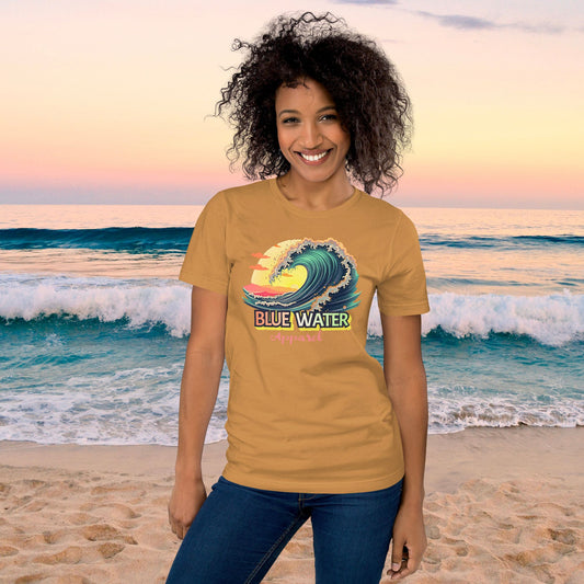 Model wearing mustard vintage surf tee on beach by blue water apparel