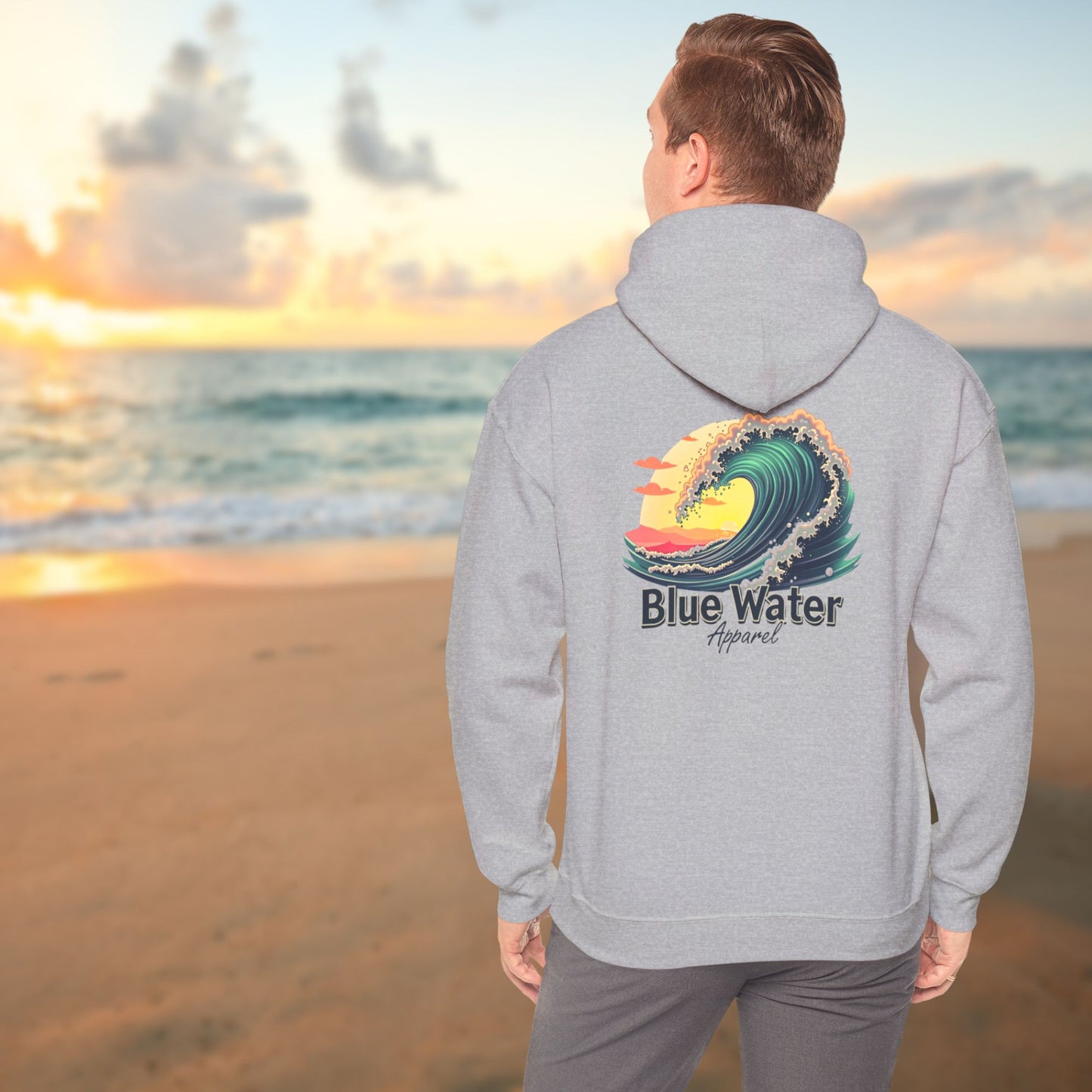 male model gazing at ocean wearing sport grey vintage surf hoodie by blue water apparel