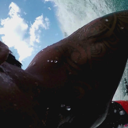 music video of surfer in curl wave by blue water apparel